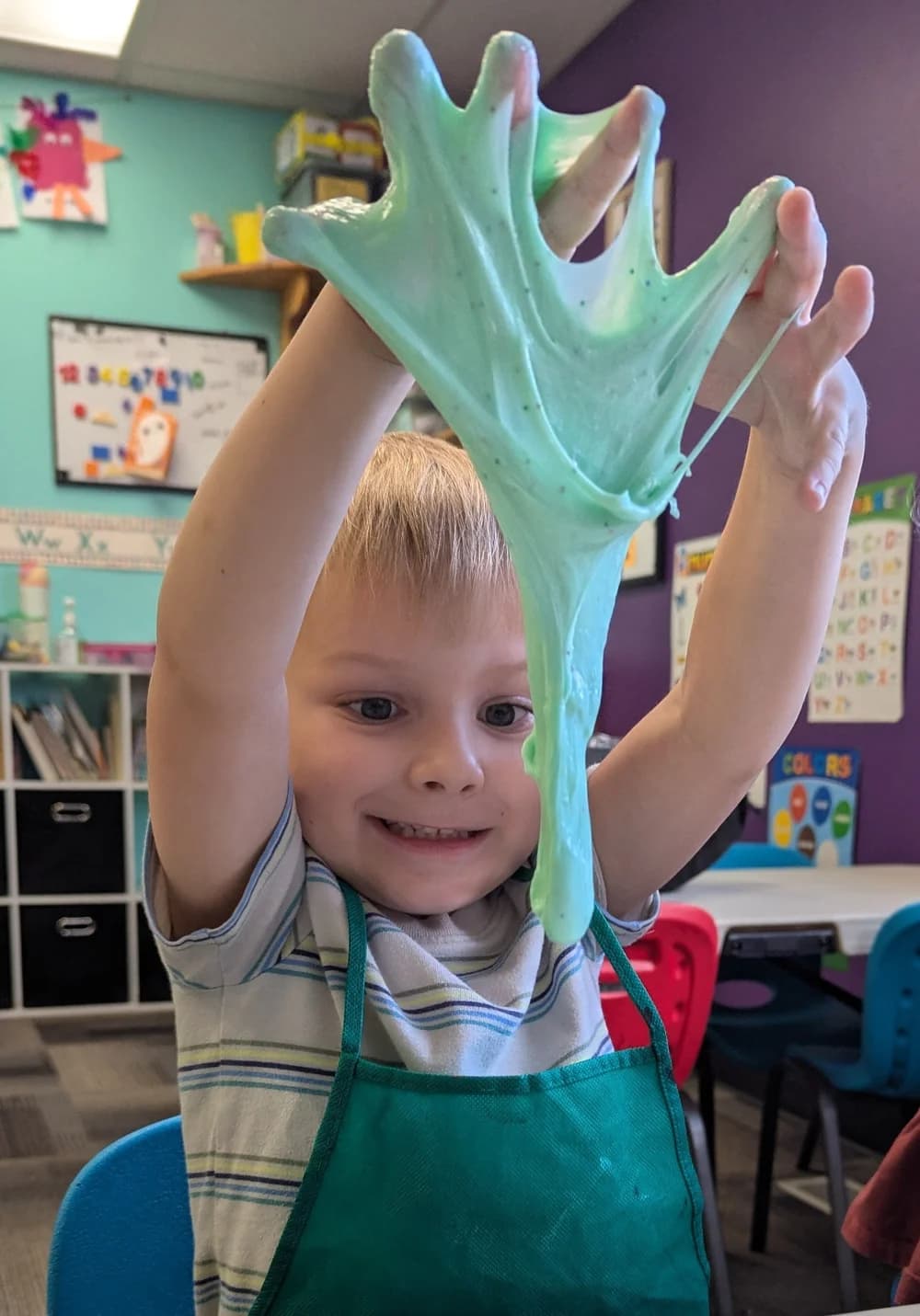 A Gym Stars preschooler doing a hands-on slime activity in the classroom